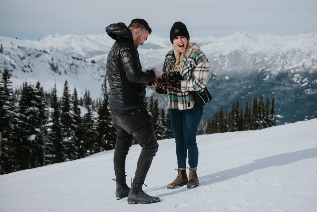 Excited girl being proposed to on top of Whistler Mountain