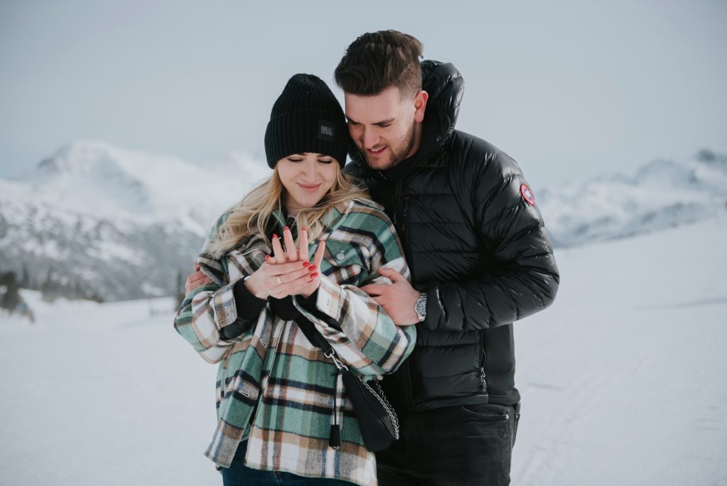 Newly engaged couple admires ring after Whistler proposal