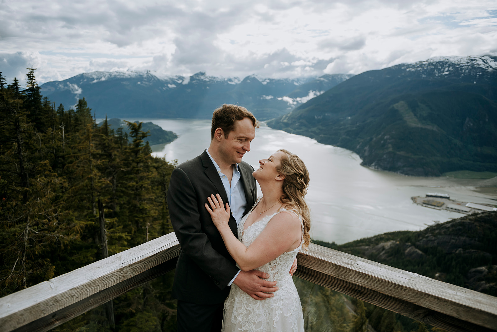 Elopement couple stands together on a bridge overlooking the Howe Sound at the Sea to Sky Gondola in Squamish