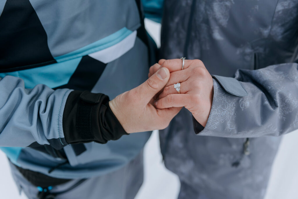 Couple holds engagement ring