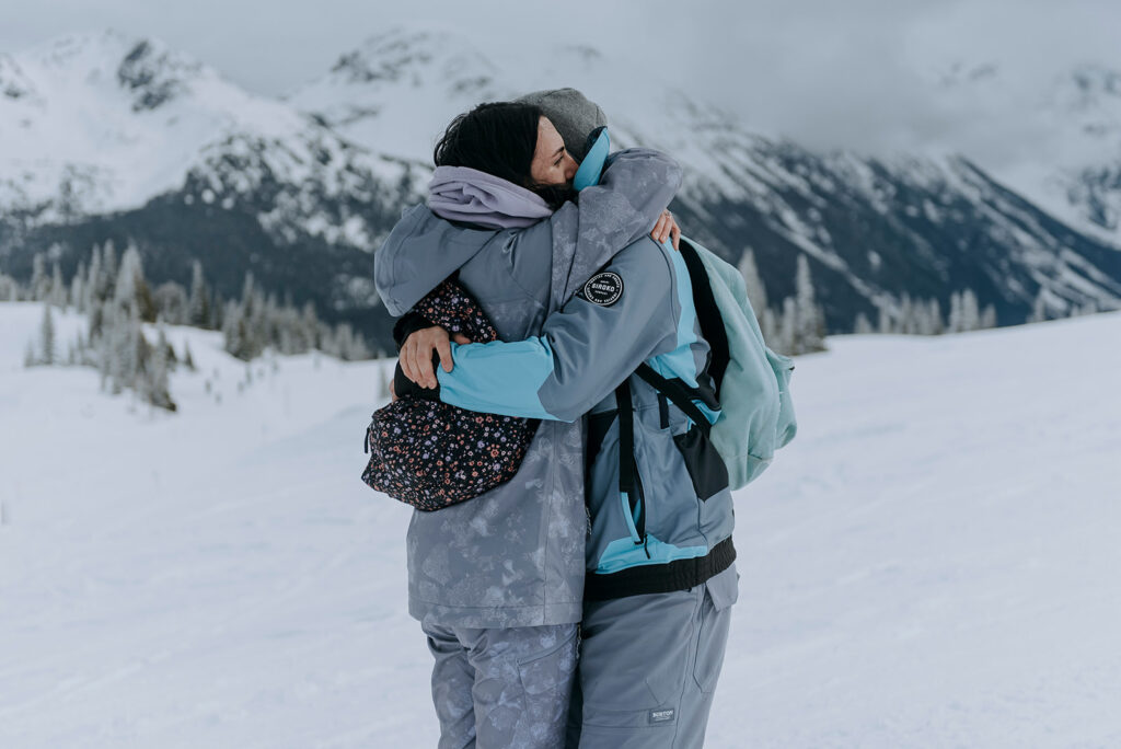Couple embrance after their proposal on Whistler Mountain